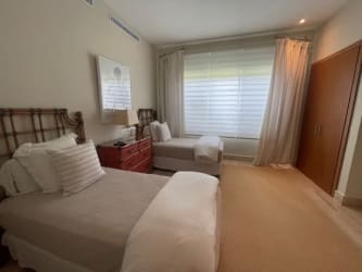 Guest bedroom with large windows neutral decor luxury villa Buenaventura Panama