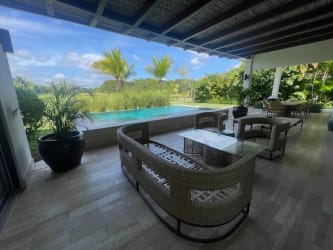 Covered patio terrace with rattan furniture overlooking private swimming pool Buenaventura Peninsula