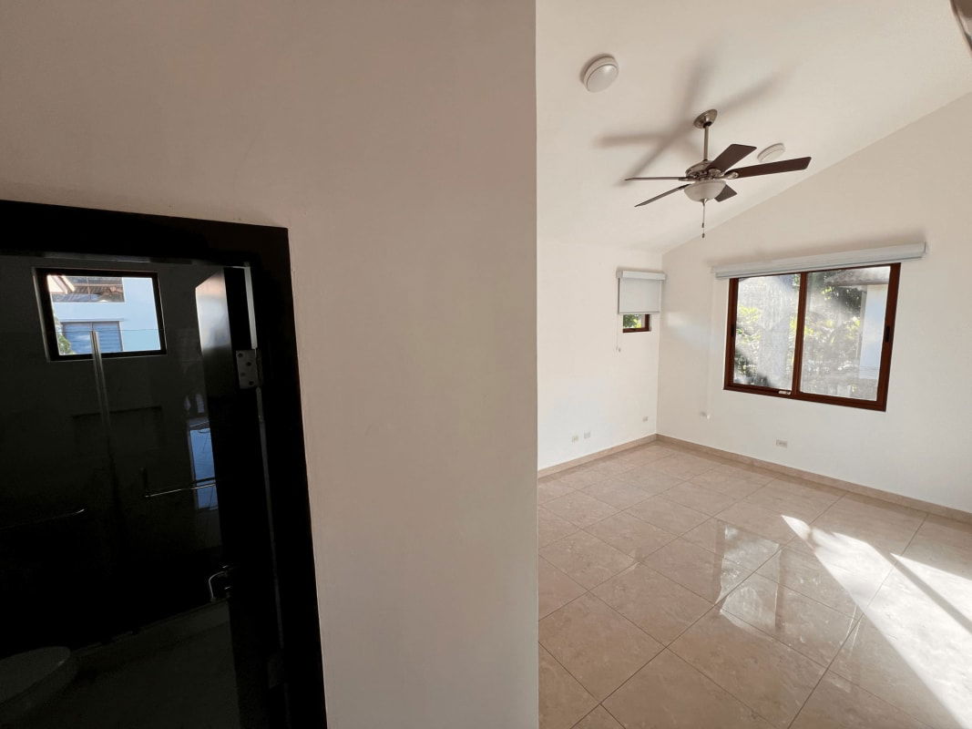 Spacious living room with tiled floor vaulted ceilings ceiling fan luxury home Clayton