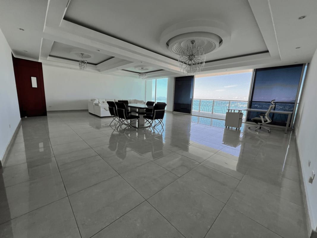 Modern open kitchen with granite countertops, island, stainless steel appliances in PH Aquamare Panama City