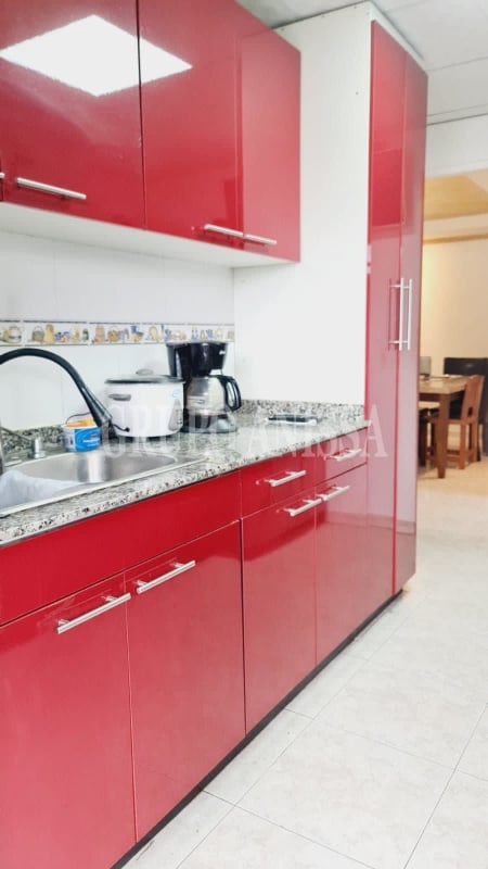 Contemporary kitchen with granite countertops and red cabinetry in Villa Zaita Palma de Mallorca Panama City