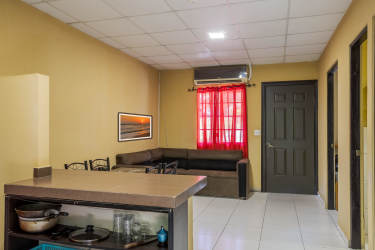 Covered patio with security grates and tiled walkway in furnished apartment complex David Panama