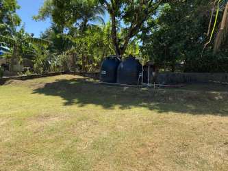 Backyard green space with water tanks Residencial David apartment complex Chiriquí