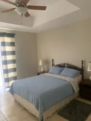 Bright bedroom with two beds, tile floor in Buenaventura beach condo