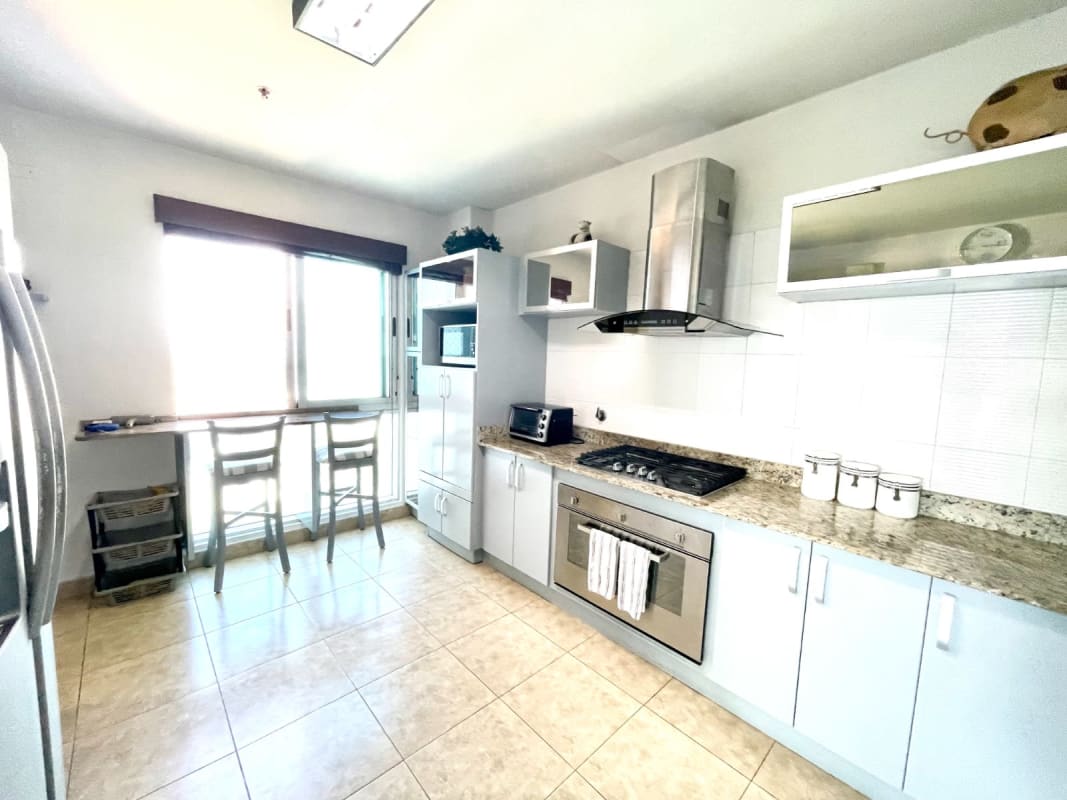 Contemporary kitchen with granite countertops, built-in appliances, breakfast nook PH Mirador Costa del Este Panama