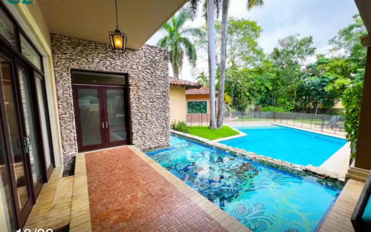 Exterior of two-story home with balconies and garden Altos del Golf Panama City