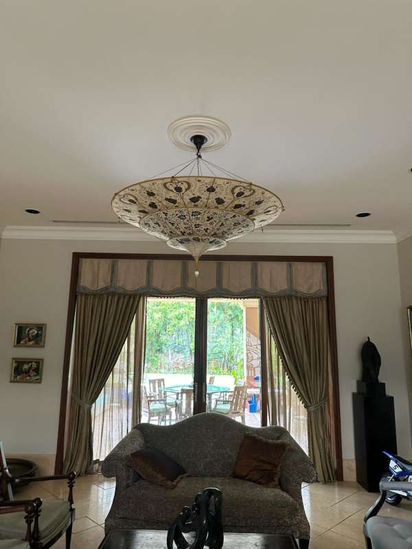 Formal dining room with round table, chandelier, mirror Panama City estate
