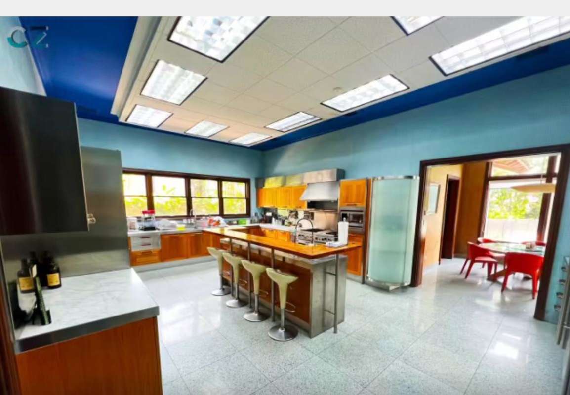 Contemporary kitchen featuring island stainless appliances Altos del Golf Panama luxury estate