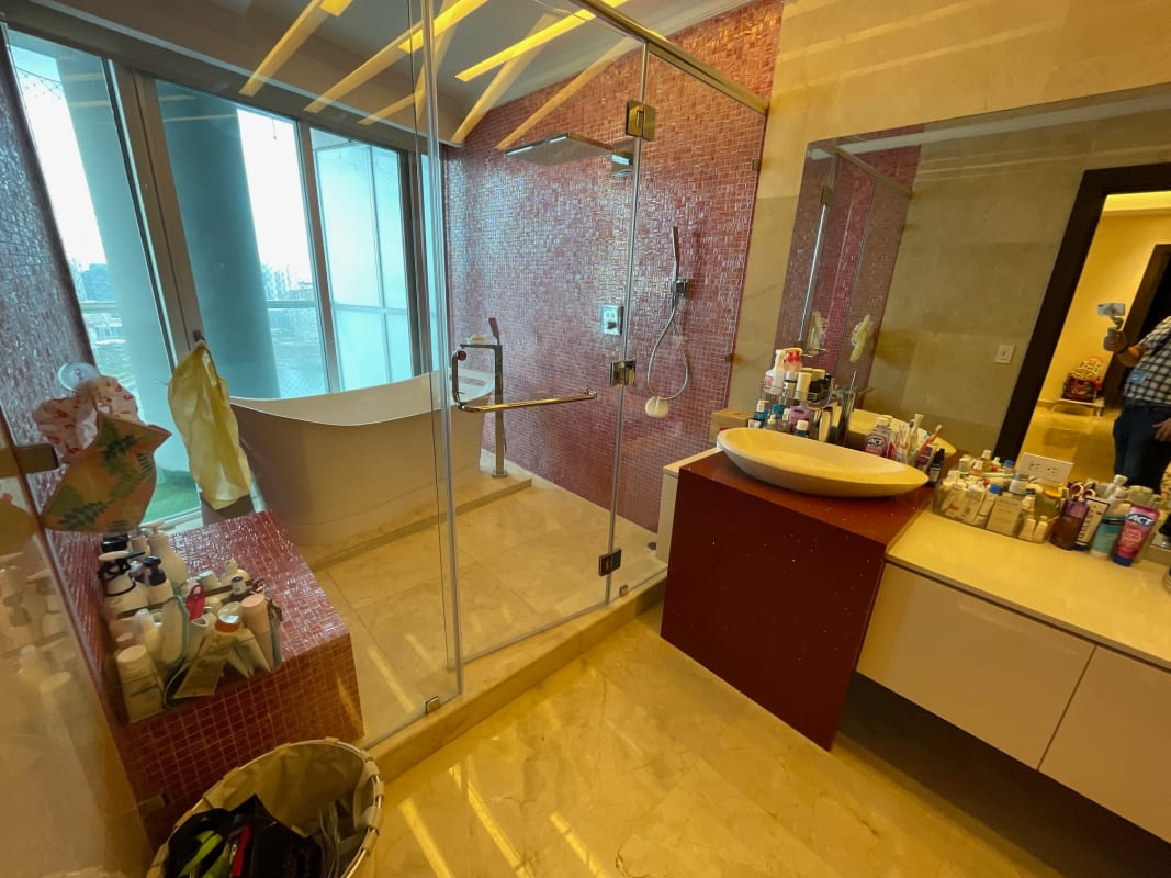 Modern bathroom with marble walls, freestanding tub, glass shower Yacht Club Panama