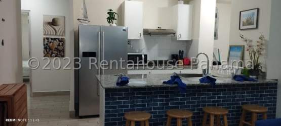 Bedroom with twin beds, coastal decor and natural light at Playa Caracol beach condo Panama