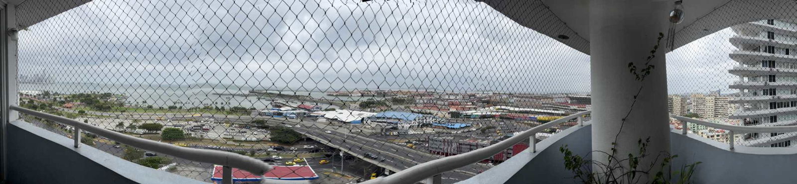 Curved balcony with protective mesh overlooking Pacific ocean and skyline from PH Bay View Avenida Balboa Panama