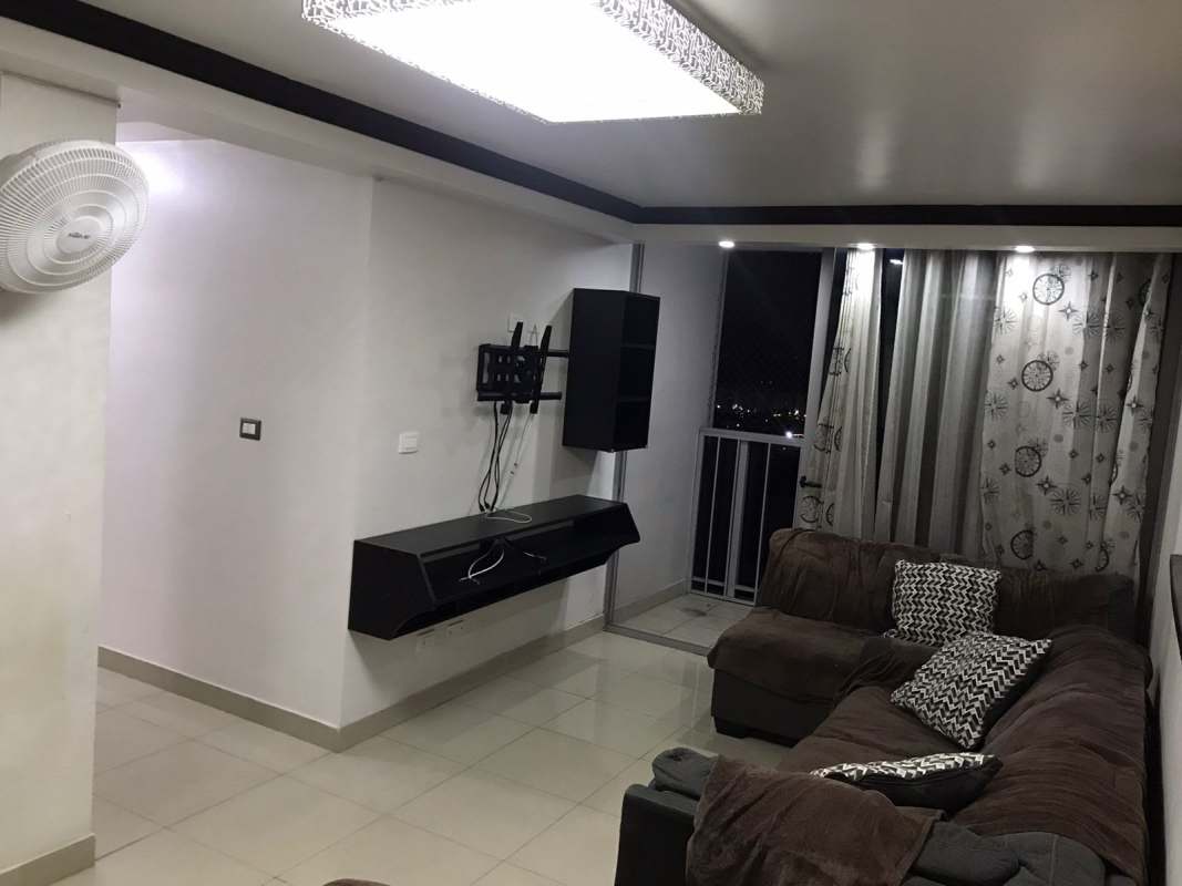 Living area with sectional sofa, balcony view, wall-mounted TV PH Rokas Condado del Rey Panama