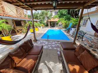 Outdoor swimming pool with hammocks, covered patio in tropical courtyard Nueva Gorgona Panama
