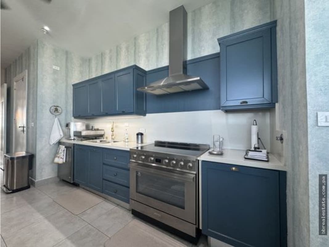 Modern designer bathroom with botanical wallpaper and vessel sink in luxury penthouse Costa del Este