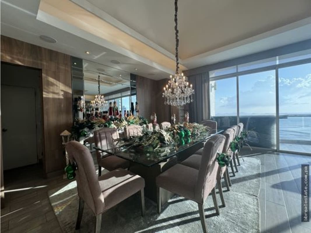 Modern kitchen with blue cabinetry, white counters and large window in luxury penthouse Costa del Este