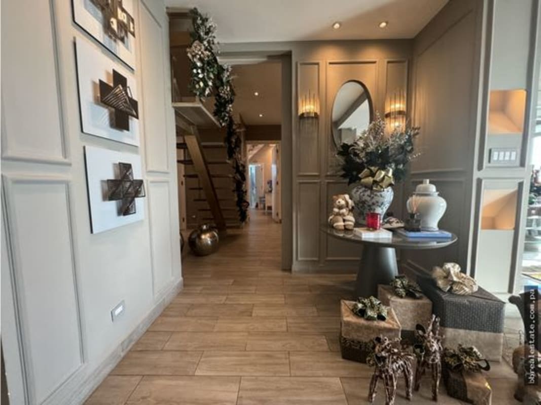 Luxury bedroom with walk-in closet and floor-to-ceiling window with ocean view in Costa del Este penthouse