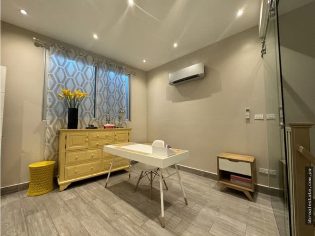 Modern home office with large windows, white desk and neutral decor Costa del Este