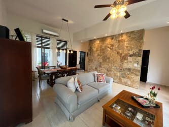 Open concept living and dining room with natural light and stair access in PH Nativa Panama Pacifico