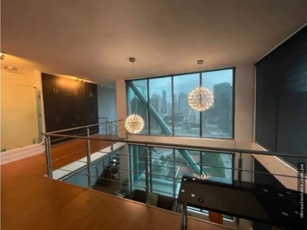 Modern loft mezzanine bedroom overlooking skyline with glass railing PH Loft Four 41 Punta Pacifica Panama