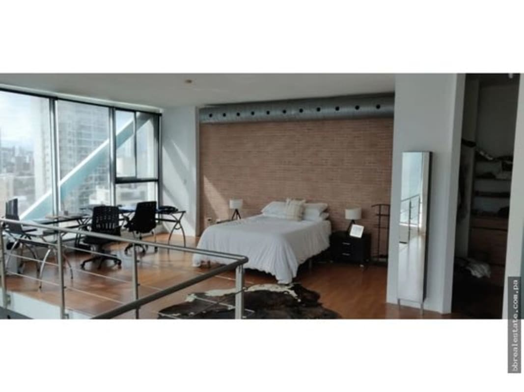 Loft style bedroom with workspace, floor-to-ceiling windows, exposed brick wall and modern design PH Loft Four 41 Punta Pacifica Panama