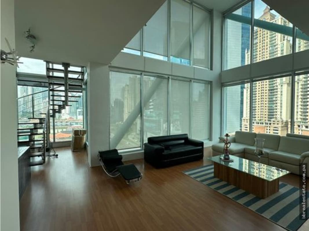 Open kitchen with granite countertops, stainless steel cabinets, and appliances in loft apartment Punta Pacifica Panama