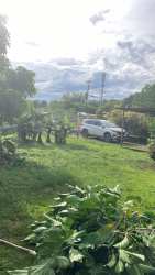 Blue house covered porch with pillars and lush garden in Villa Esperanza Penonomé Panama