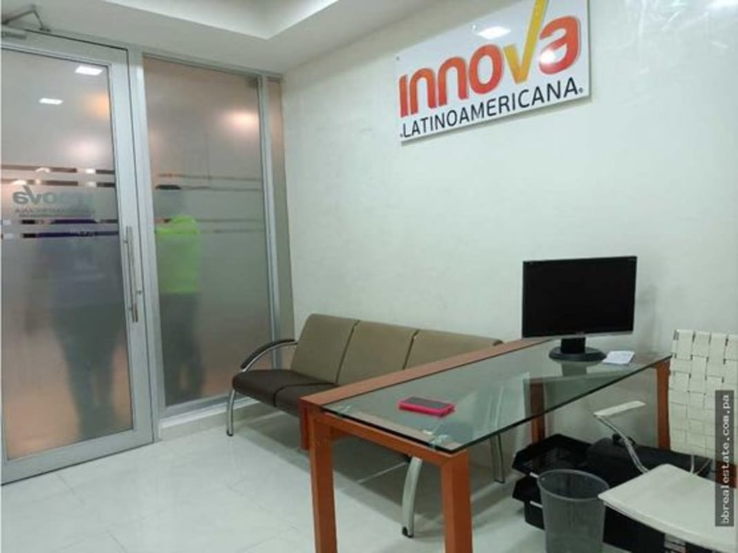 Reception area with signage and glass wall partition inside Torre Ancón office Costa del Este Panama