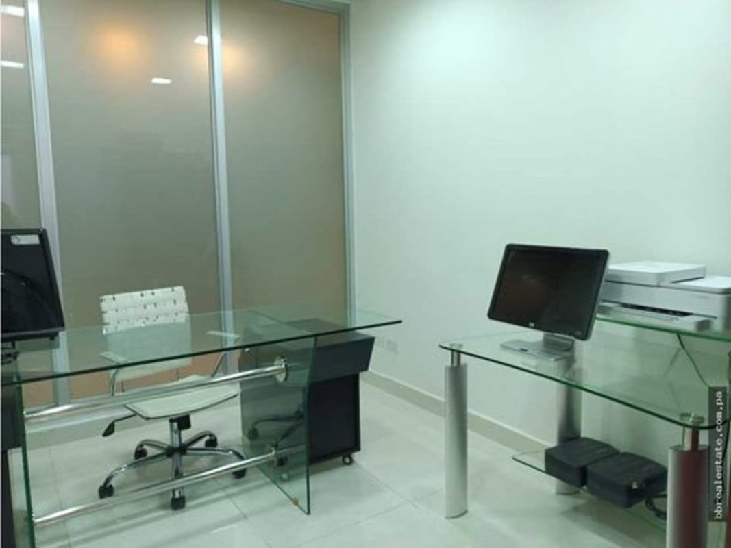 Furnished private office with frosted glass partitions and desks in Torre Ancón Costa del Este Panama