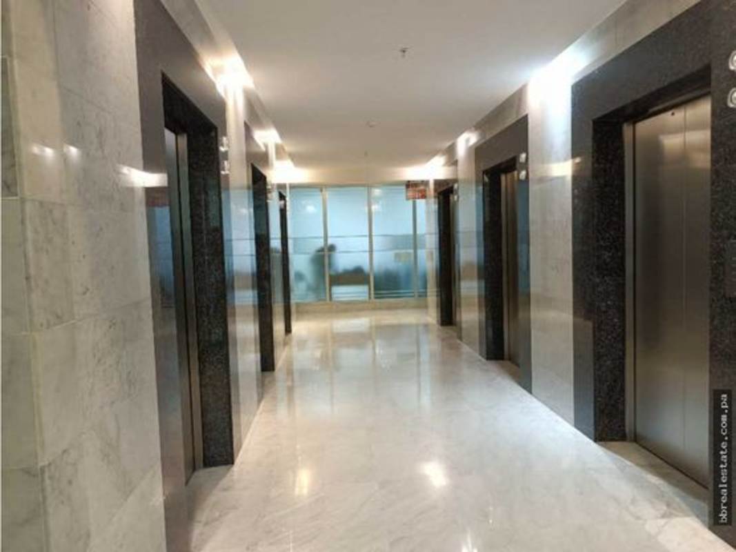 Grand lobby entrance with glass walls, marble flooring and Christmas tree Torre Ancón Panama City