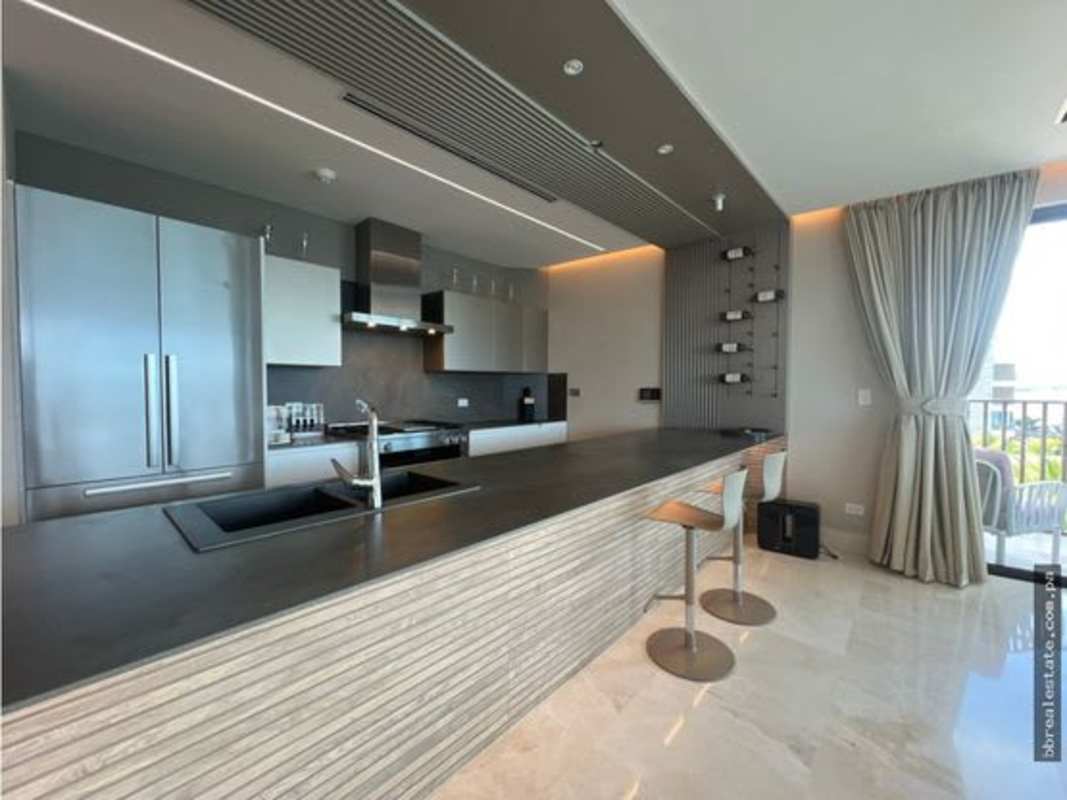 Modern kitchen island with built-in appliances at PH Seascape Ocean Reef Panama City