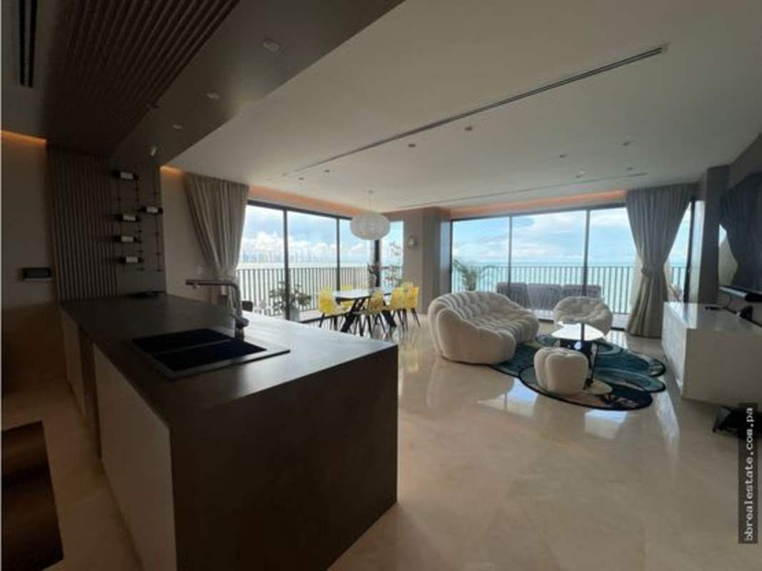 Modern open-plan living and kitchen with floor-to-ceiling ocean views at PH Seascape Ocean Reef Panama