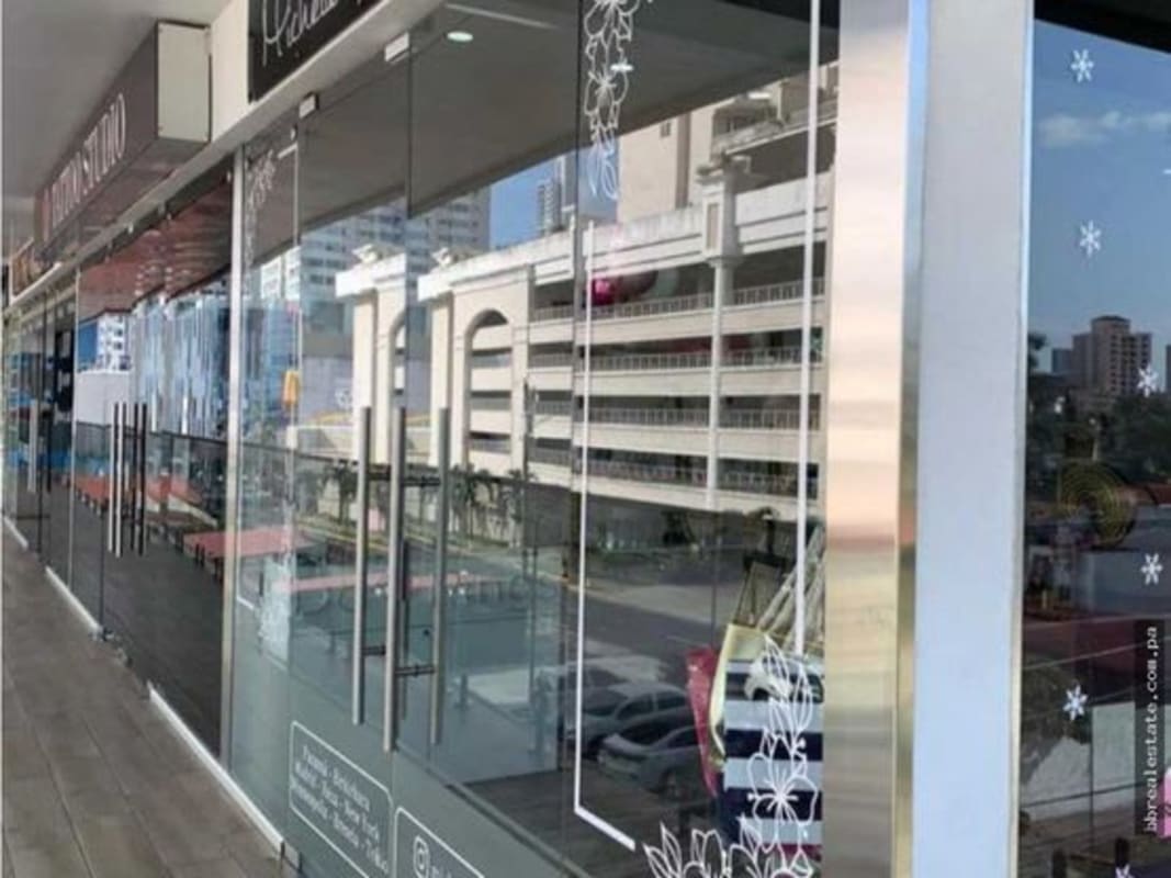 Chic pink-themed boutique showroom with floating shelves, mirrors Midtown Plaza Panama City