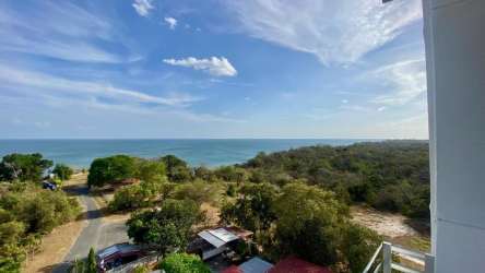 Large beachfront infinity pool illuminated at night in PH Ocean View Playa Corona Panama