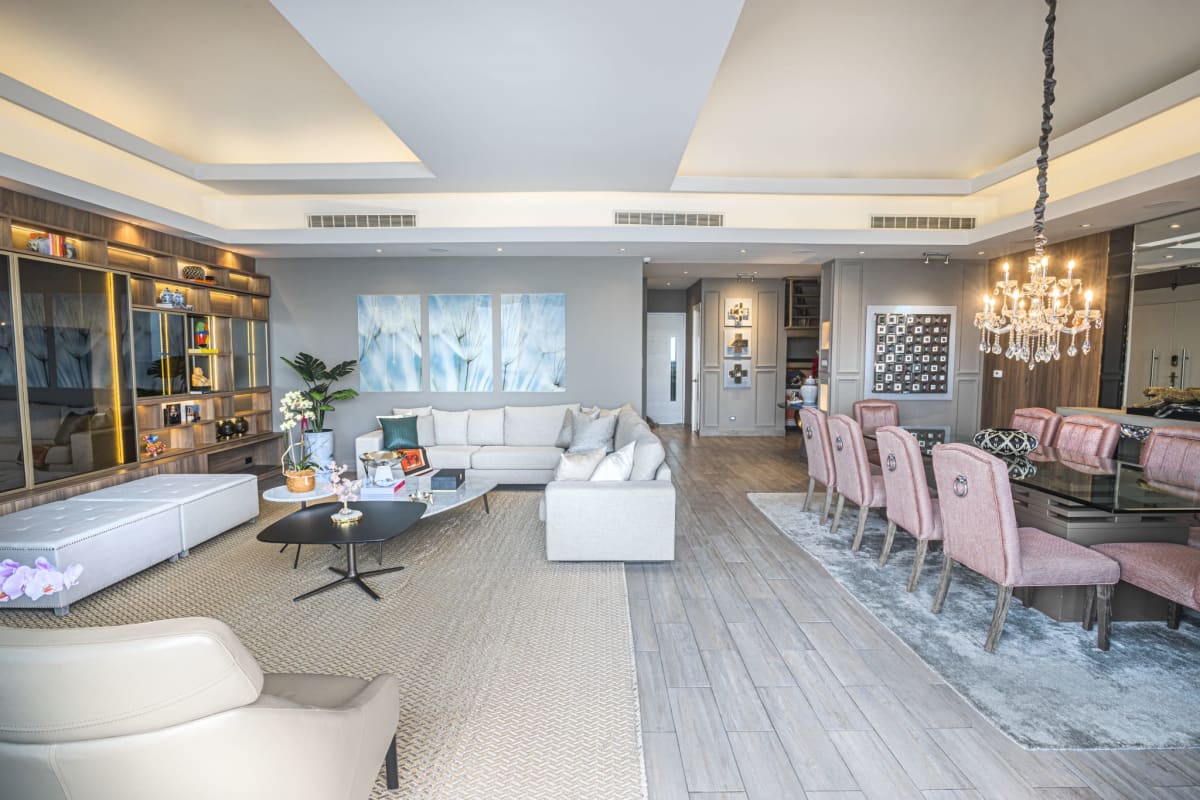 French-style blue cabinetry kitchen with quartz counters and island in penthouse Panama