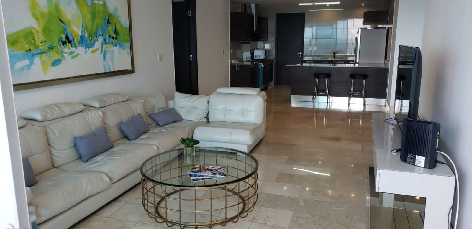 Open concept living dining with ocean backdrop marble floors Grand Tower Punta Pacifica Panama