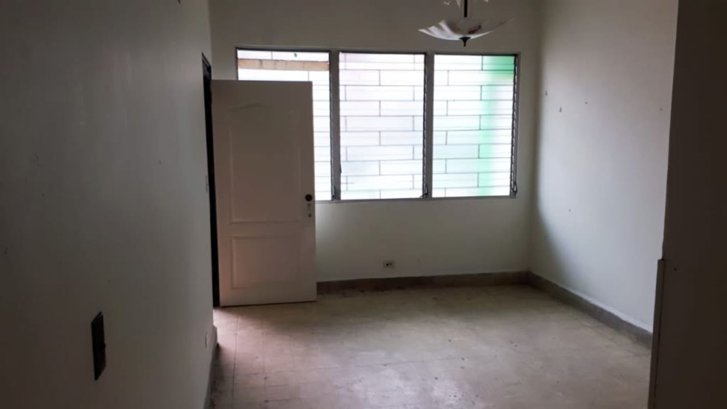 Room with frosted glass window and open door minimalistic colonial Casco Viejo