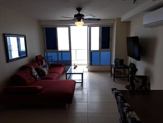 Spacious master bedroom with large windows facing ocean balcony Coronado Bay Panama