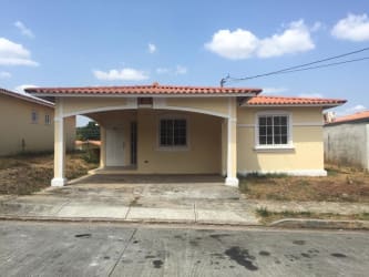 Zenith arch entrance, covered carport light yellow house for sale West Village Vista Alegre Arraiján Panama