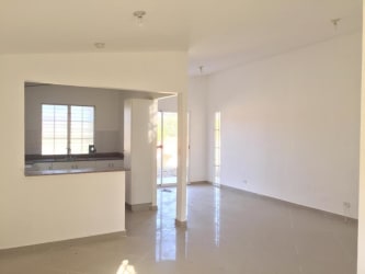 Open-plan living space with white walls ceramic tiles at West Village Residences Arraiján Panama