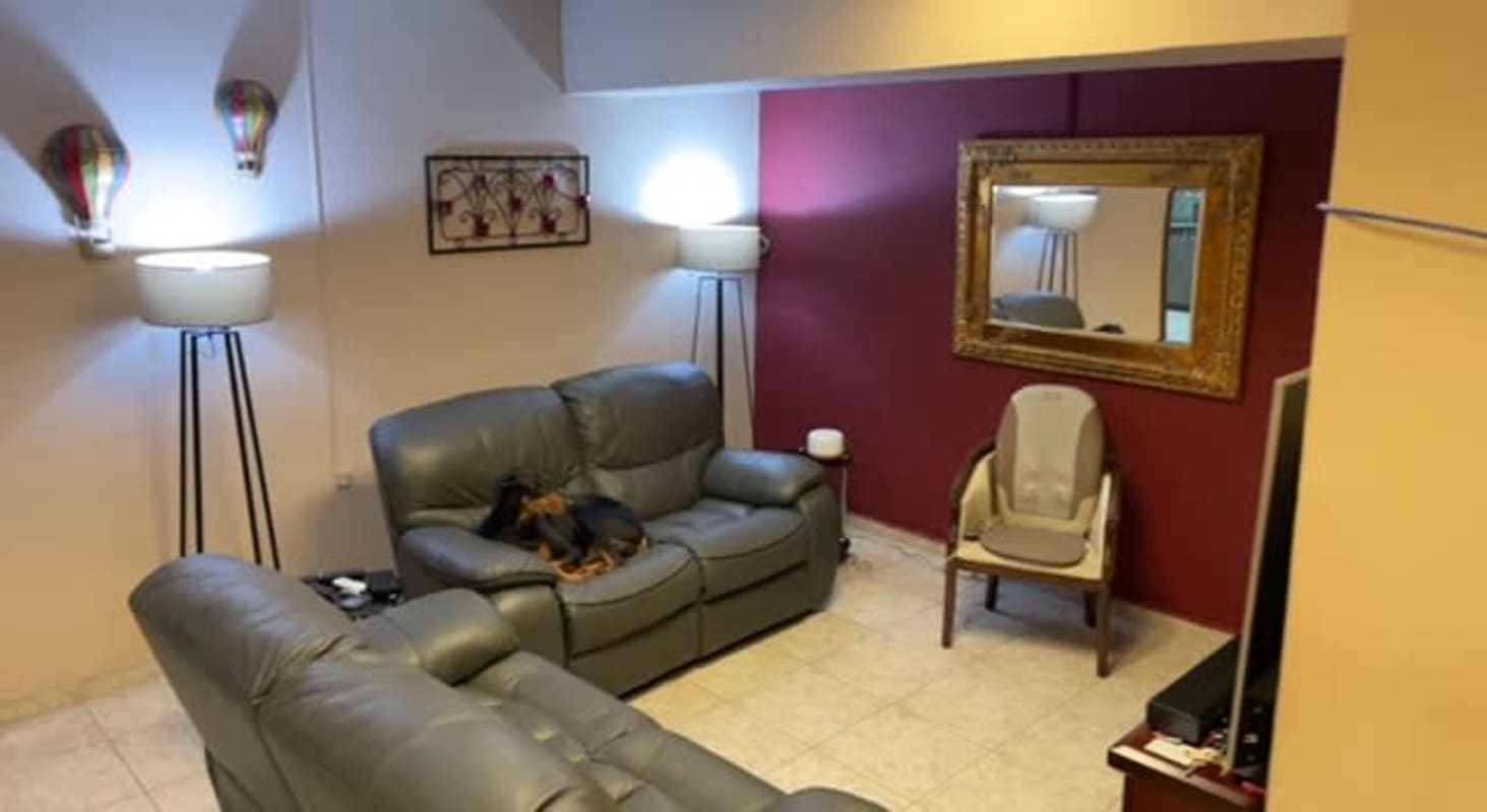 Contemporary living space with mirror, leather sofas, bright lighting inside Calidonia multi-use building