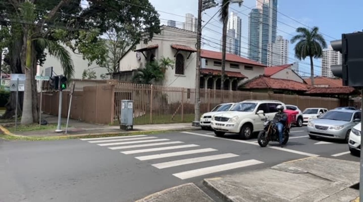 Contemporary living room with accent walls, mirror, leather sofas in Calidonia Panama commercial apartment