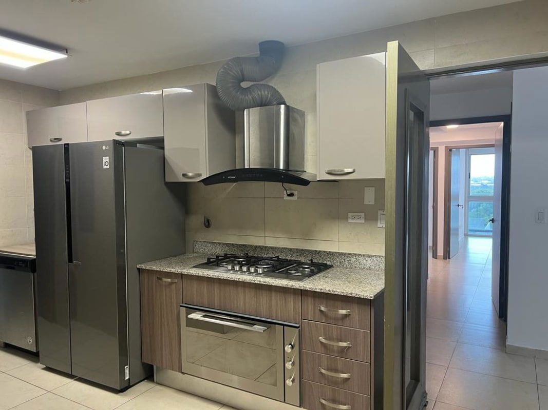 Gourmet kitchen with granite counters and stainless appliances at PH Lumiere Costa del Este Panama