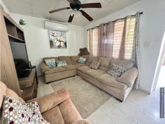 Artificial grass backyard with children's swing and playground, covered terrace