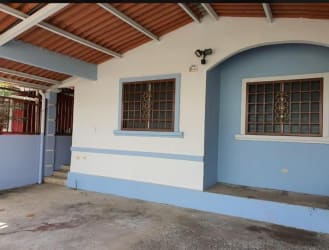 Spacious living room with white ceramic floors, ceiling fan, AC, window security