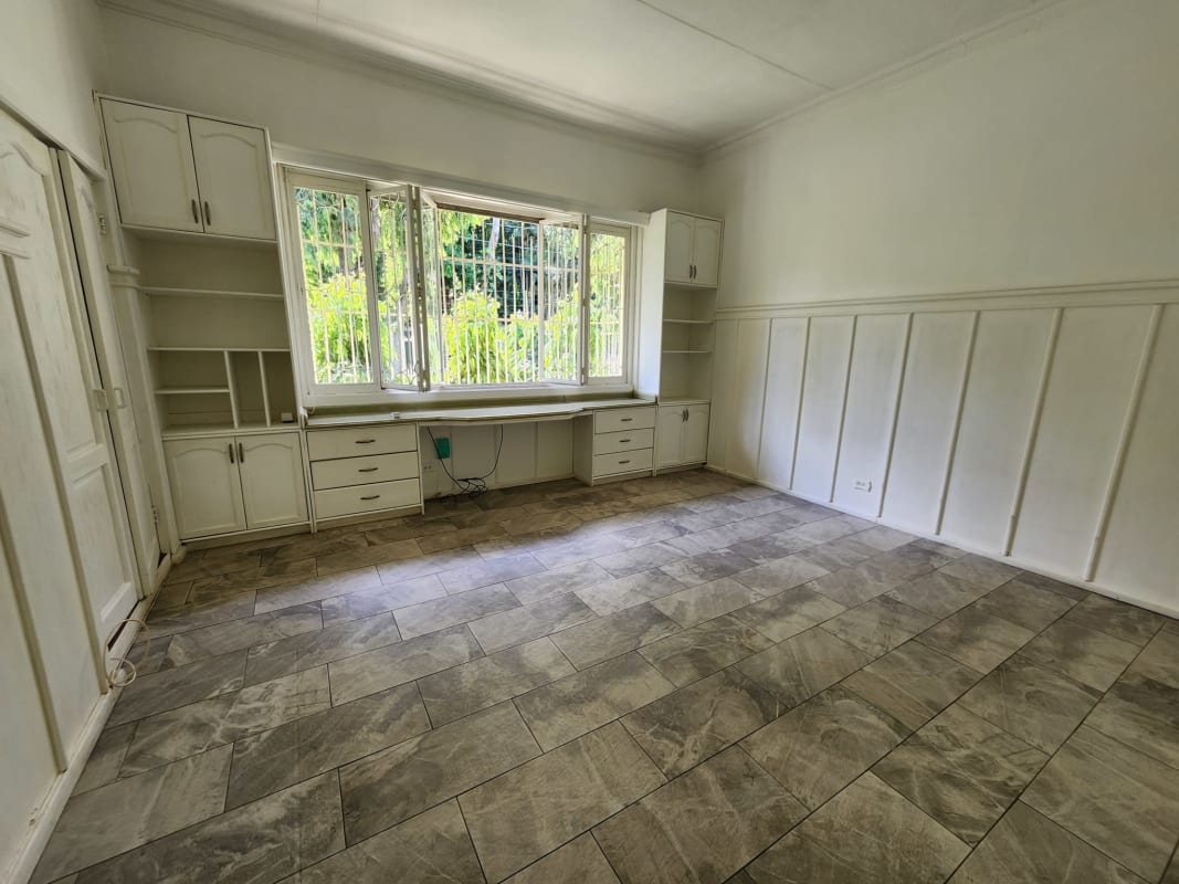 Traditional living room with large windows, hardwood floors, natural light in luxury estate Panama City