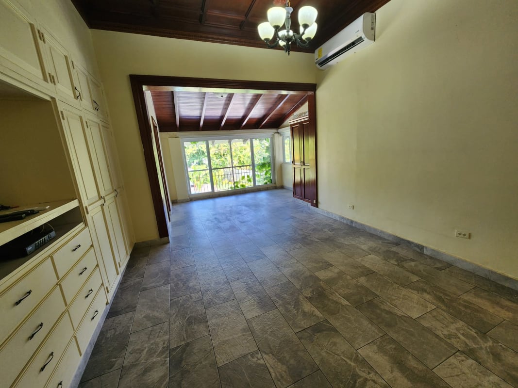 Large living area with built-in cabinets traditional styling in Panama estate home