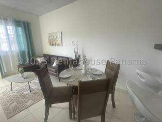 Bright open living and dining space with tile floor and window in Altos de la Mitra house