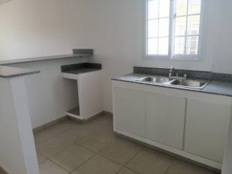 Simple tiled bathroom with shower and sink in house for sale La Chorrera Panama