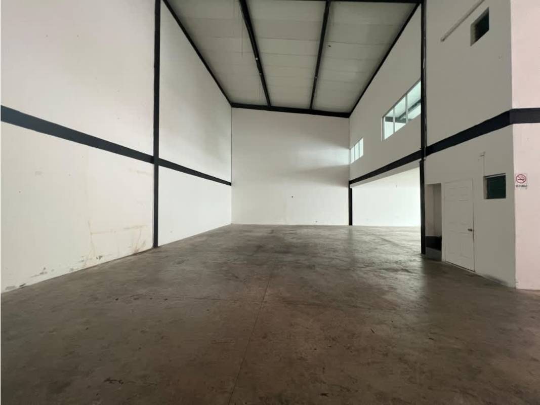 Spacious interior warehouse with exposed beams tiled floor and glass door in Mañanitas Panama