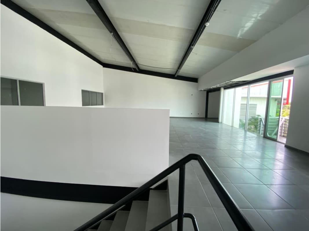 Facade warehouse with glass windows roll-up garage door parking Panama City